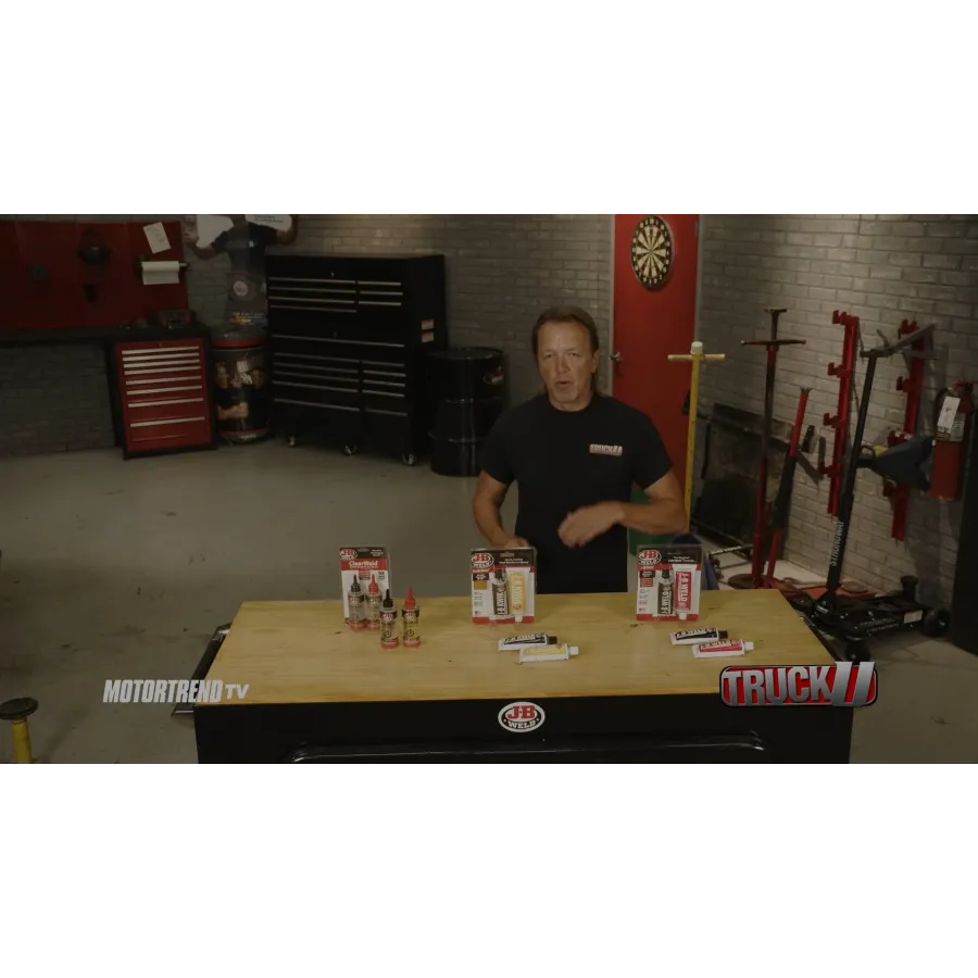 Larry Stogner sitting at a table with a group of cans and bottles