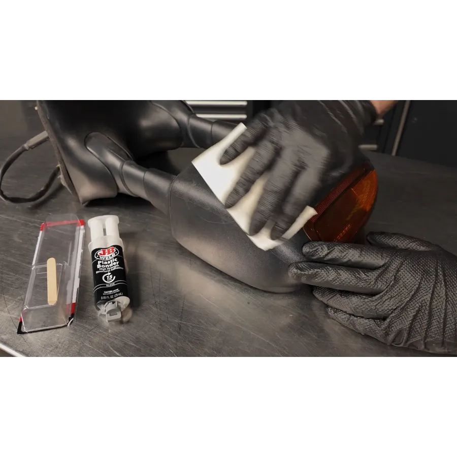 a black shoe on a wooden surface